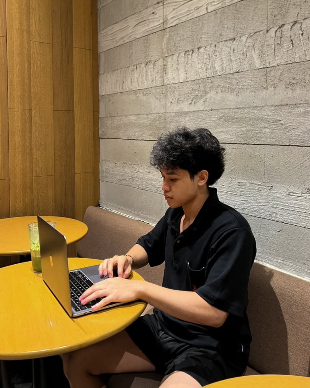 Typing on MacBook at Starbucks