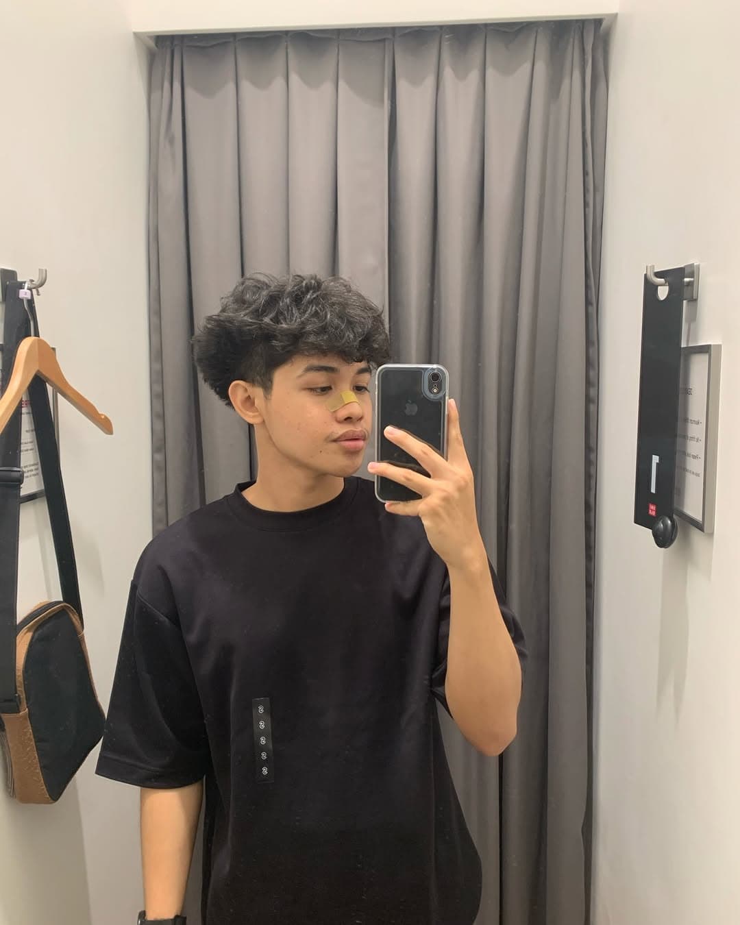 Fit check mirror shot at Uniqlo